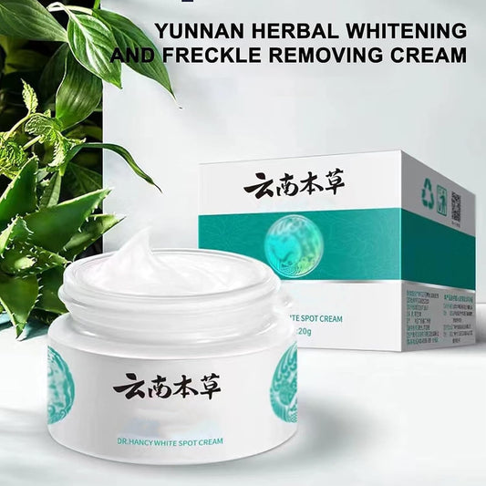 Yunnan herbal whitening and freckle removing cream in white jar with green packaging and plant background