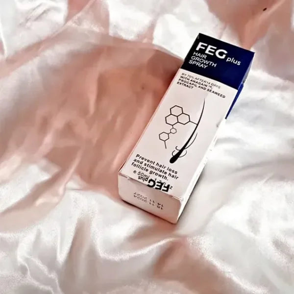 FEG Plus hair growth spray box on silky white and light pink fabric to prevent hair loss and stimulate follicles