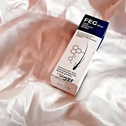 FEG Plus hair growth spray box on silky white and light pink fabric to prevent hair loss and stimulate follicles
