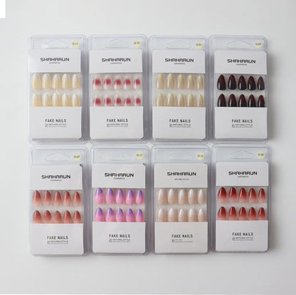 Eight sets of Shaharun brand fake nails in various natural and colorful shades, neatly packaged on white background
